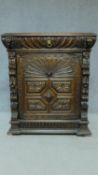 A 19th century Flemish carved oak pier cabinet with frieze drawer above panel door. H.111 W.96 D.