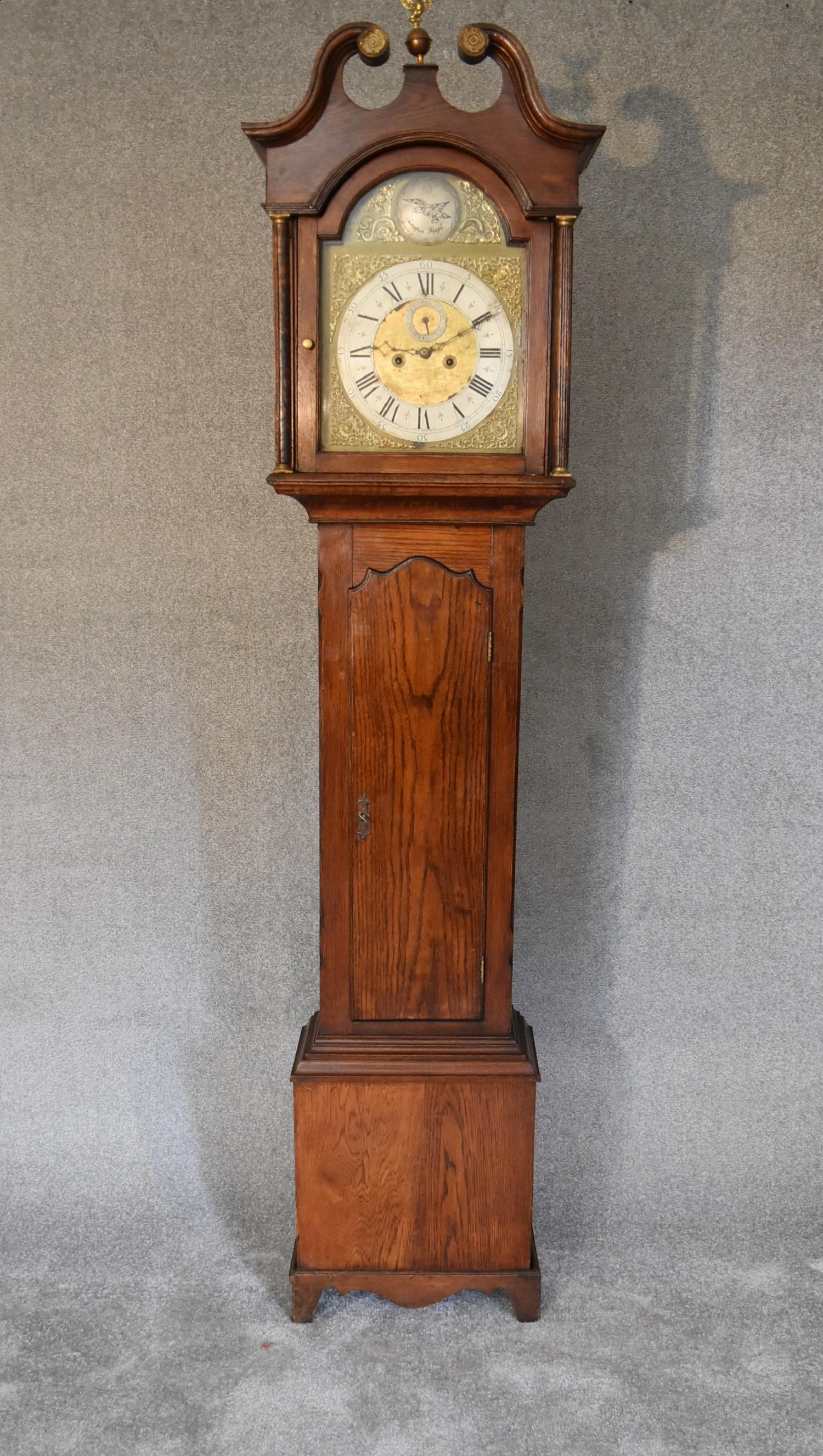 A 19th century oak cased eight day longcase clock with brass dial, has weights and pendulum. H.230 x