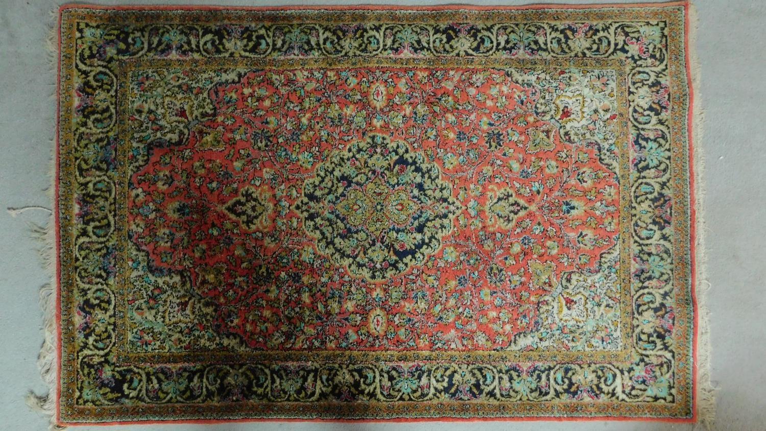 A Persian Sarouk Style rug, the central double pendant medallion with repeating petal motifs, on