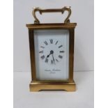 A 20th century brass carriage clock by Charles Frodsham, London, with bevelled glass sides and white