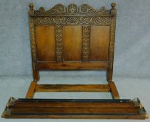 An antique style Ipswich oak bedstead carved with floral motifs. H.144 W.220 D.152cm (to take a