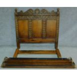 An antique style Ipswich oak bedstead carved with floral motifs. H.144 W.220 D.152cm (to take a