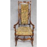 A Victorian rosewood armchair in the Carolean style in its original tapestry upholstery. H.129cm