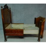 A 19th century French burr walnut nursing bed with floral carvings to the top and to the legs,