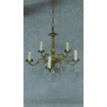 A gilt metal five branch chandelier with crystal drops. H.44 W.53cm