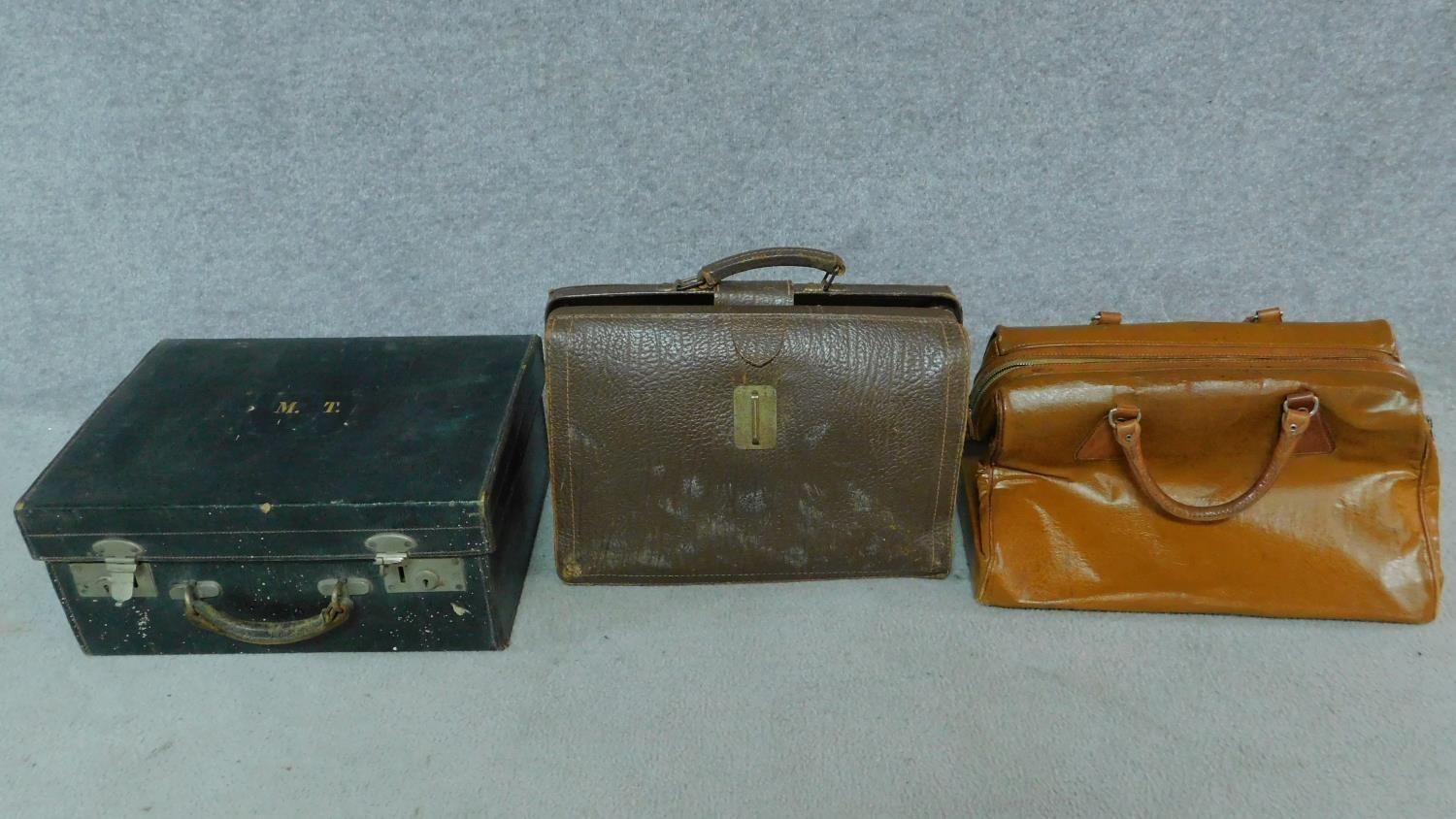 One vintage leather suitcase together with two vintage leather men's bags, one by Antler, one