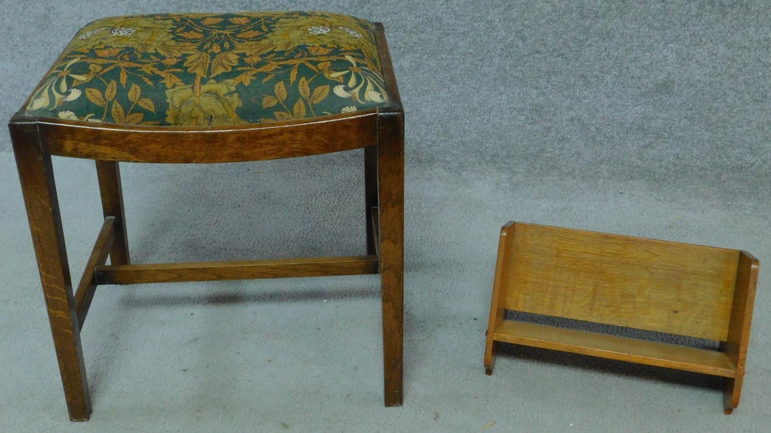 An oak Arts and Crafts book trough, signed by R. G. Collins to the bottom and an oak stool in