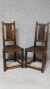 A pair of Carolean style oak hall chairs with linenfold carving to backs. H.103cm