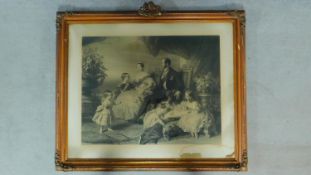 A framed and glazed print depicting Queen Victoria and the Royal family. 92x110cm