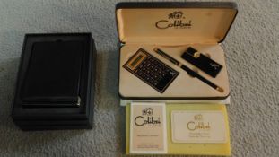 A vintage Johnny Walker cased Colibri of London stationery set including a calculator, lighter and
