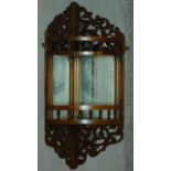 A 19th century walnut mirrored back open corner cabinet with pierced fretwork. H.64cm