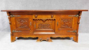 A mid 20th century Continental carved oak sideboard decorated with animal and scroll work