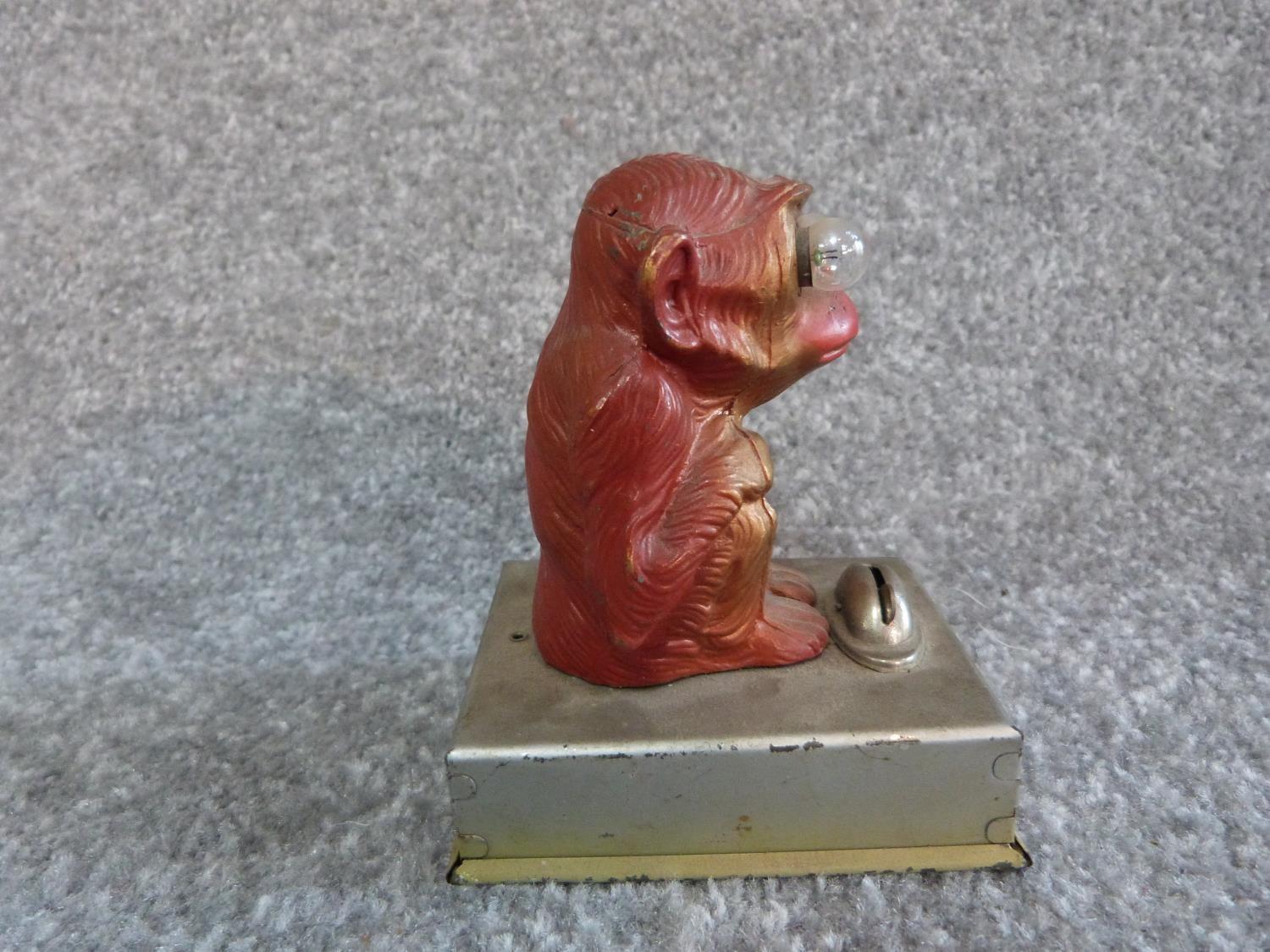 A vintage brass singing decanter and a painted monkey tin plate light. Sings Little Brown Jug. H - Image 8 of 11