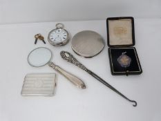 A collection of silver items including a silver pocket watch, antique silver compact, silver