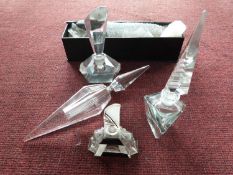 A collection of four cut clear glass scent bottles. A modern cut glass diamond bottle with spire