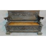 An 18th century Italian carved oak hall bench fitted hinged seating compartment on block scroll