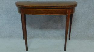 A Georgian mahogany card table raised on tapering square legs. H.73 W.92 D.90cm