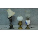 A spelter cherub table lamp, another Dutch style and a brass oil lamp. H.67cm