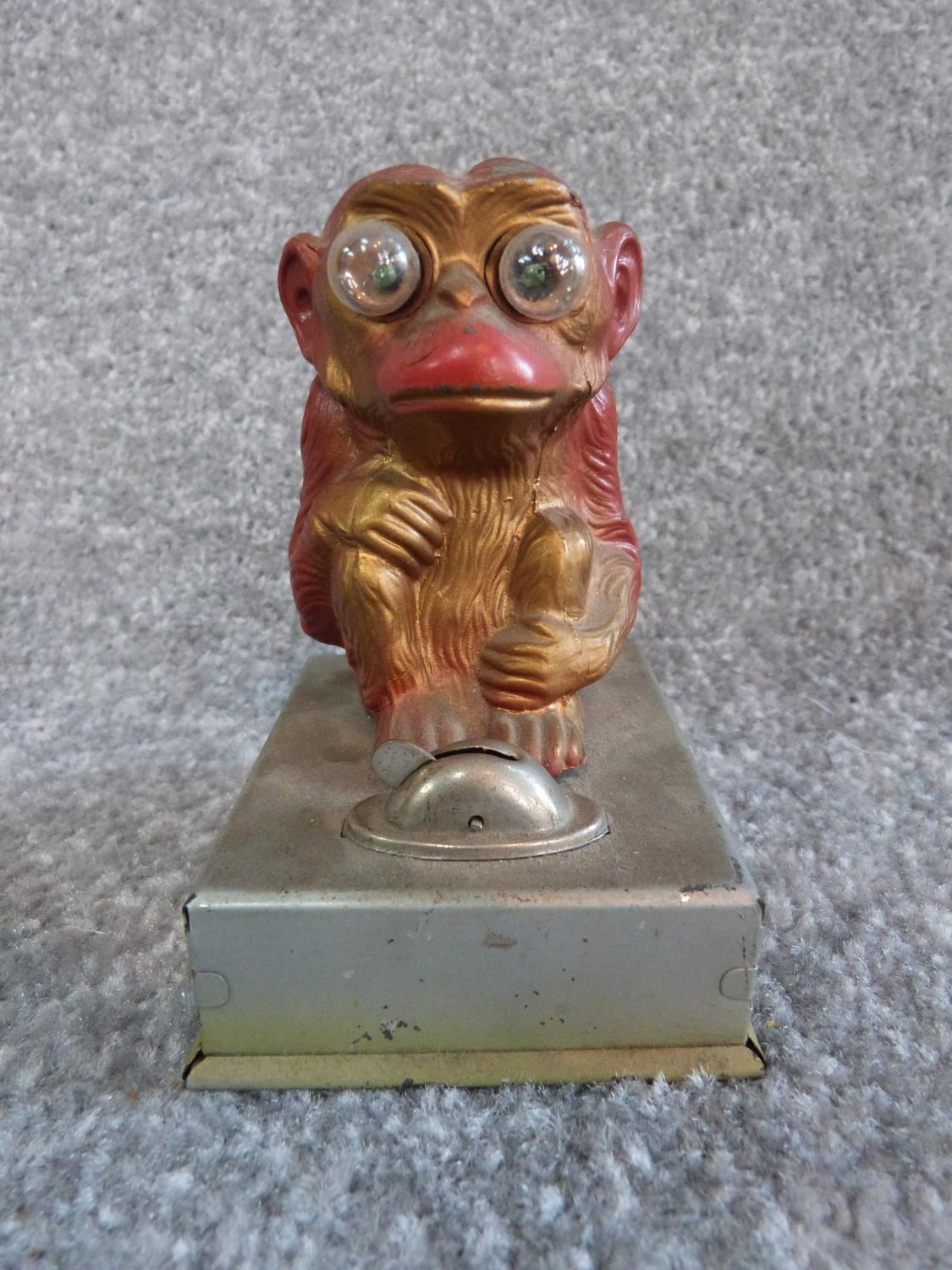 A vintage brass singing decanter and a painted monkey tin plate light. Sings Little Brown Jug. H - Image 7 of 11