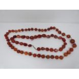 Two strings of antique Carnelian beads. One necklace comprised of 43 round knotted polished beads,