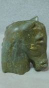 A carved green hard stone horses head sculpture. H.38cm