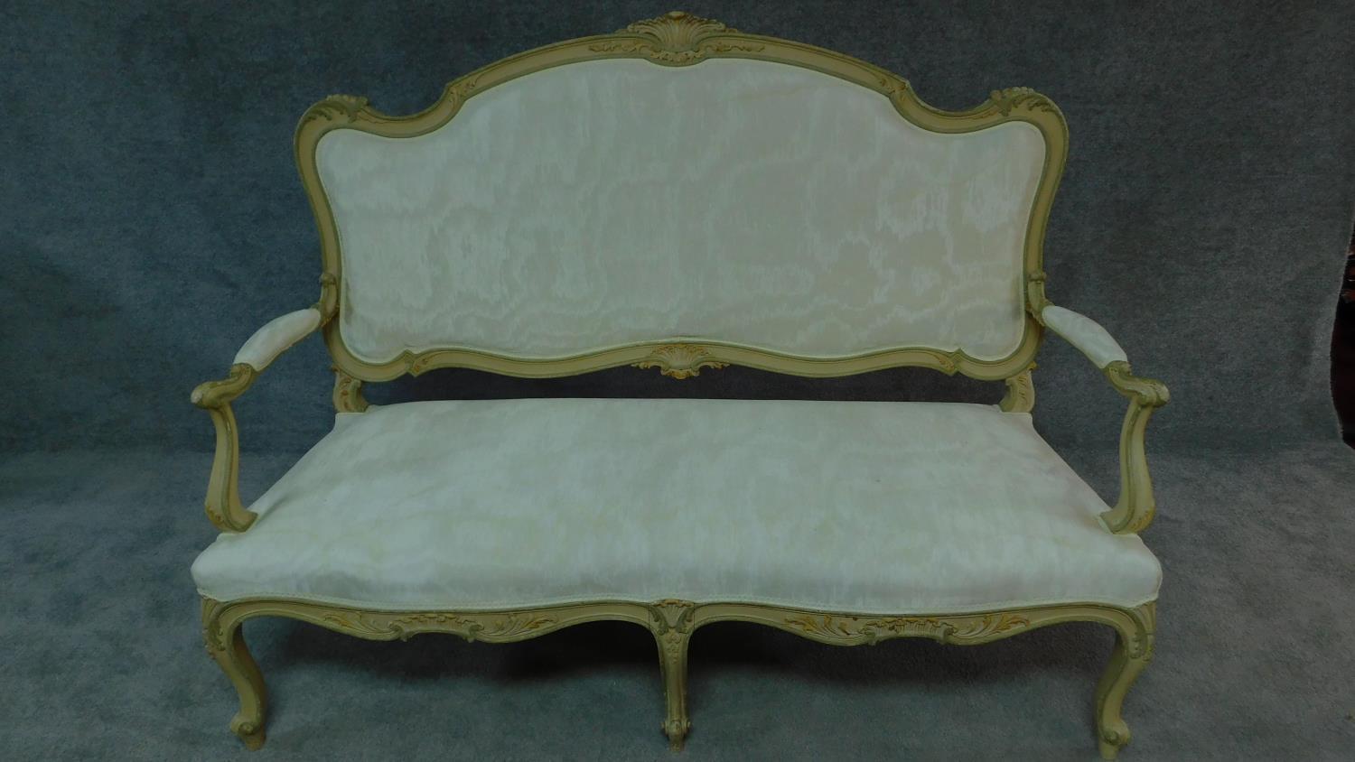 A 19th century Italian carved and painted canape in ivory damask on cabriole supports. H.112 W.148