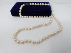 A vintage baroque cultured pearl necklace with an abstract white metal non opening clasp with brooch