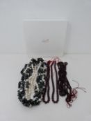 A three strand gemstone necklace and four strands of almandine garnet beads. The three strand