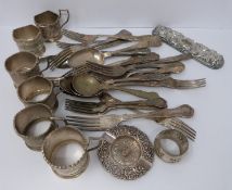 A collection of silver plated cutlery, cup covers and other items.