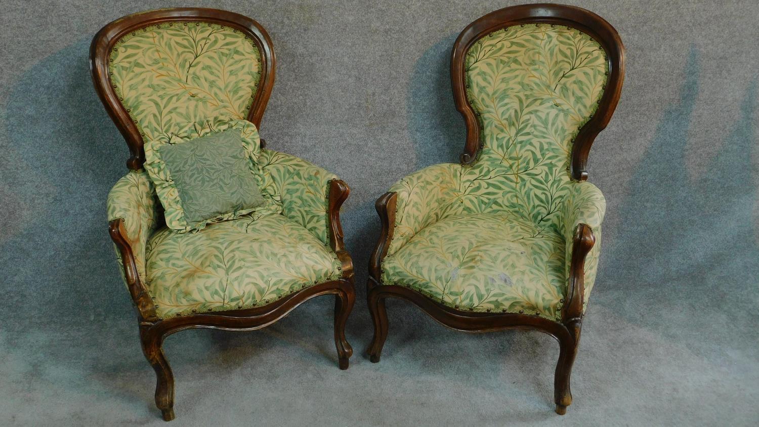 A near pair of French style walnut framed spoon back armchairs on cabriole supports. H.101cm