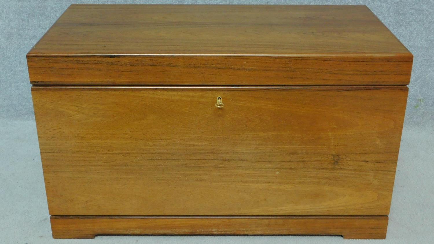 A 1950's Danish rosewood blanket box fitted with two velvet lined sliding shelves by designer Kaj