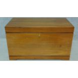 A 1950's Danish rosewood blanket box fitted with two velvet lined sliding shelves by designer Kaj