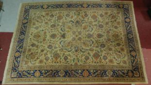 A Kashan style rug, all over spandrel motifs with repeating petal motifs on an ivory field,
