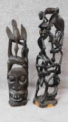 An African carving of stylised figural form and another similar. From Tanzania. H.66cm