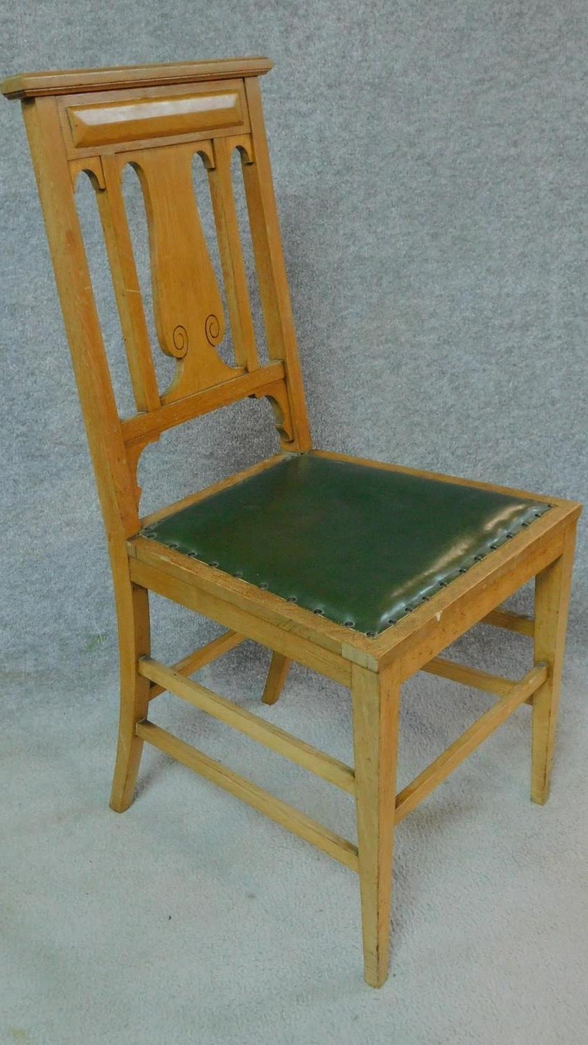 A set of four Art Nouveau oak chairs with carved back and green leather upholstery raised on - Image 2 of 7