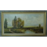 A framed oil on canvas landscape, signed by Luwig Fahl. 59x109cm