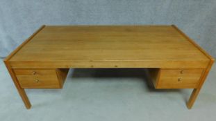 A large vintage teak pedestal desk. H.72 W.200 D.100cm