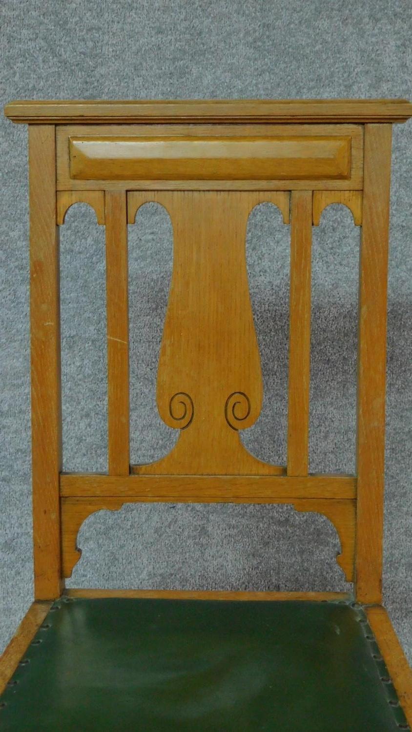 A set of four Art Nouveau oak chairs with carved back and green leather upholstery raised on - Image 3 of 7