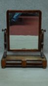 A 19th century mahogany toilet mirror fitted with two frieze drawers. H.70cm