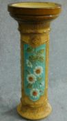 An antique majolica Burmantofts Jardiniere stand with floral motifs. H.67 W.29cm