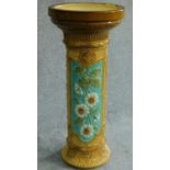 An antique majolica Burmantofts Jardiniere stand with floral motifs. H.67 W.29cm