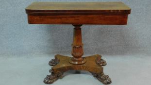 A Victorian walnut card game table raised on tapering stretchered support decorated with lion carved