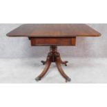 A Regency mahogany drop flap Pembroke table fitted end drawer on swept fluted quadruped supports.