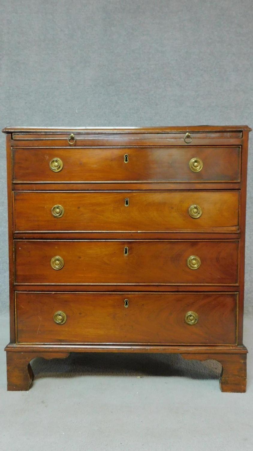 A Georgian mahogany chest of four long drawers fitted with brush slide on bracket feet. H.80 W.74