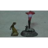 A signed vintage Burger bronze of a lady throwing a ball and an antique cast metal spill vase of a