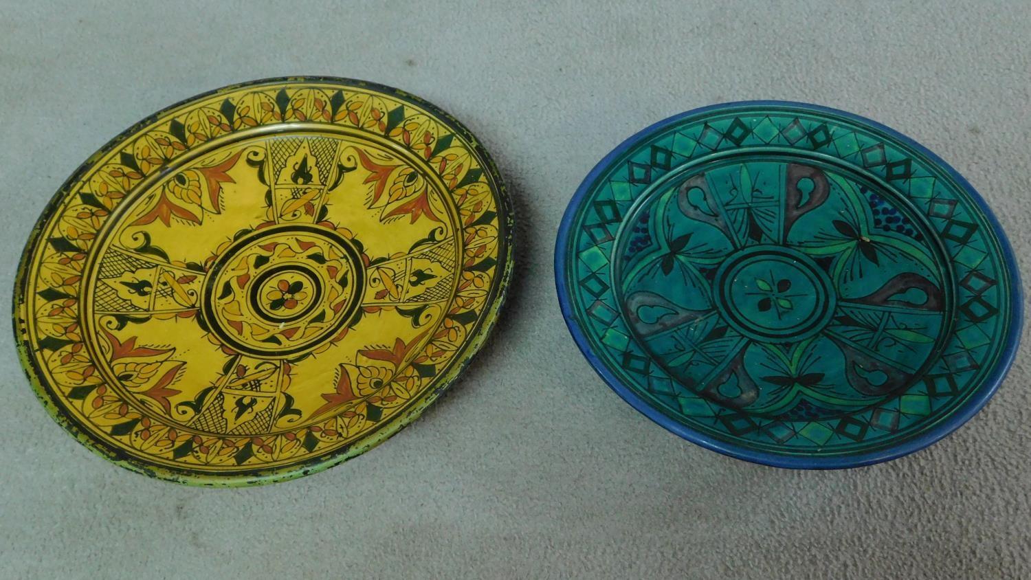 A pair of ceramic glazed plates with bold geometric designs. 39x39cm (largest)