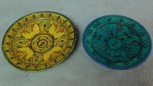 A pair of ceramic glazed plates with bold geometric designs. 39x39cm (largest)