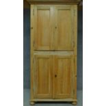 A 19th century pitch pine two part cupboard fitted with shelves. H.203 W.103 D.46cm