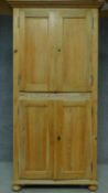 A 19th century pitch pine two part cupboard fitted with shelves. H.203 W.103 D.46cm