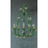 A metal framed six branch chandelier with naturalistic decoration. H.61 W.47cm